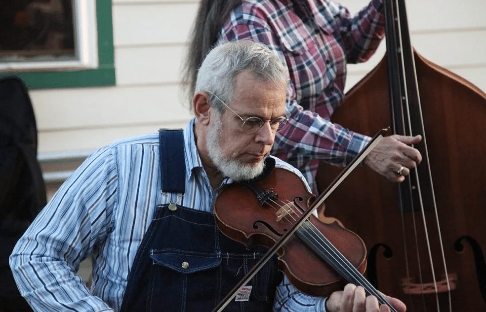 courtesy of the Washingtonian Floyd County Resident wearing overalls plays the fiddle outside the Floyd Country Store