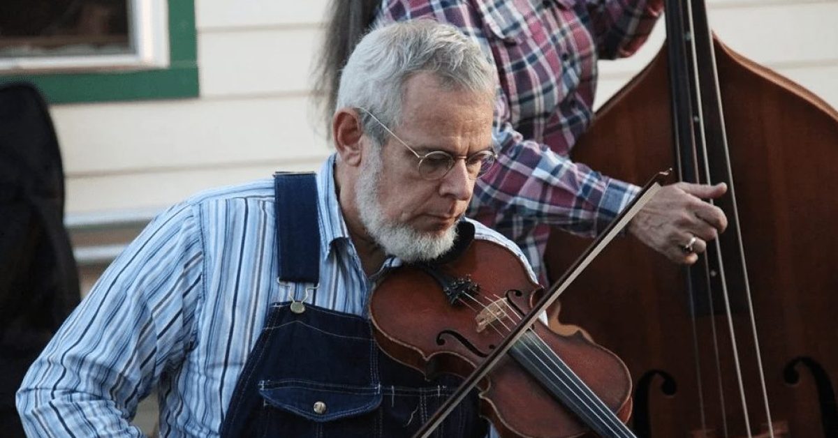 courtesy of the Washingtonian Floyd County Resident wearing overalls plays the fiddle outside the Floyd Country Store